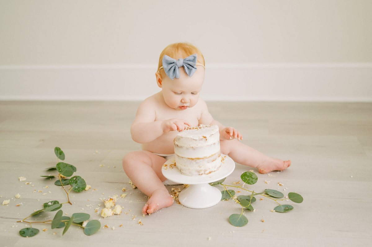Baby with a first birthday cake
